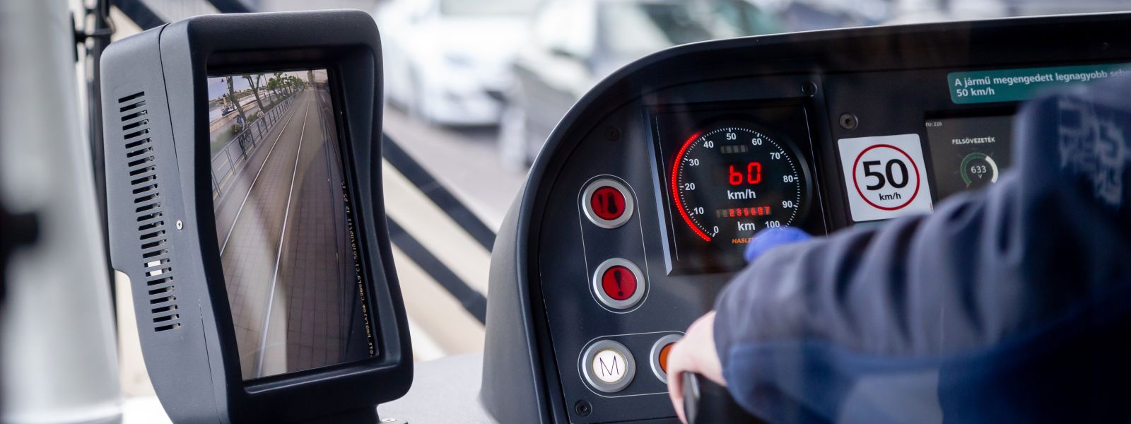 Operator at a workstation with dashboard and digital display